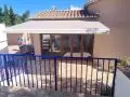 Toldo de brazos con motor y central sol viento